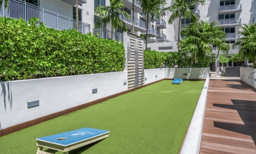 cornhole set on grass area of roof deck
