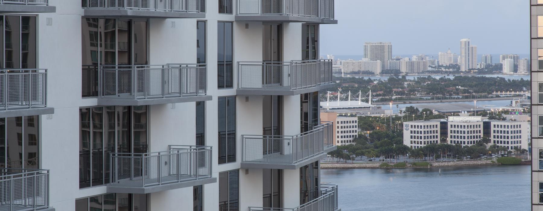 a building with a body of water in the background