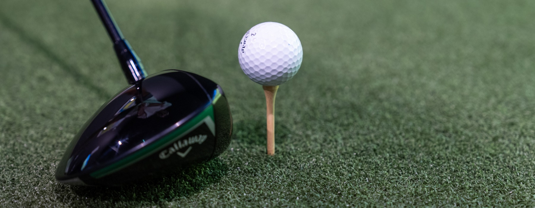 golf club and tee on turf