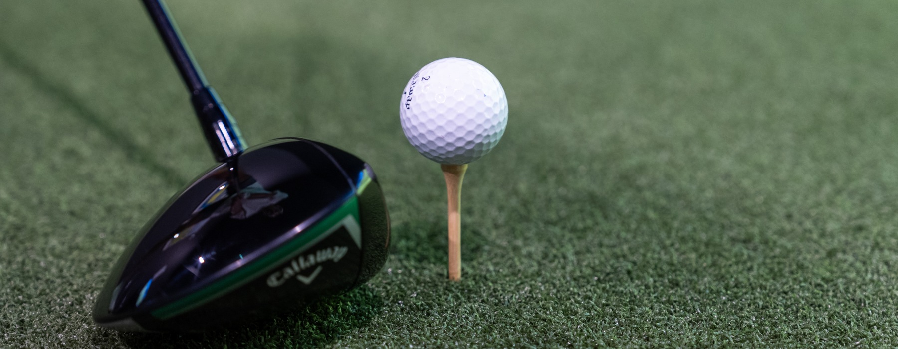 golf club and tee on turf