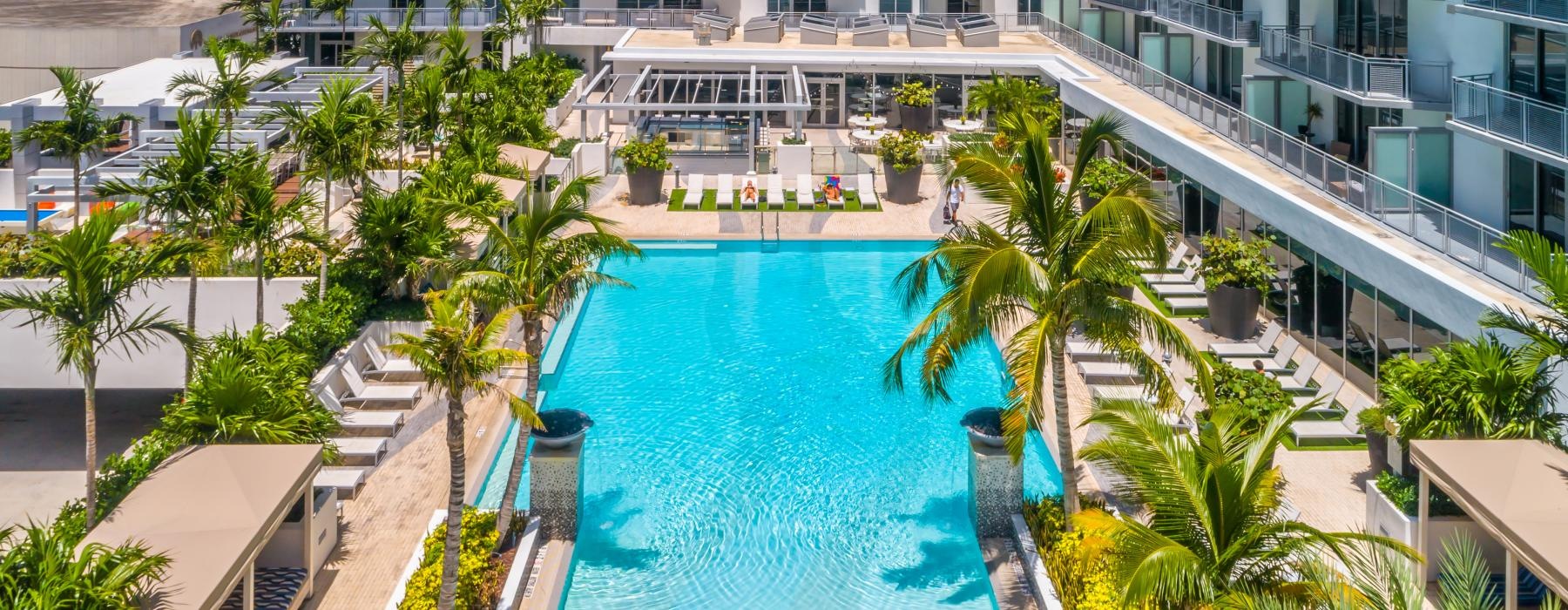 a pool with trees and buildings around it